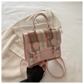 Detail of checkered bow backpack with silver buckle straps and adjustable handles - Pink