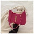 Detail of rose red leather underarm bag with gold lock buckle and chain on beige blazer - Rose Pink