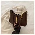 Detail of dark brown leather underarm bag featuring a gold buckle and chain strap - Coffee