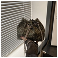 Detail of leopard print bucket bag with silver chain strap and white pearl accents - Green
