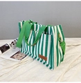 Green and white striped canvas tote bag with dual front pockets and shoulder strap - Green