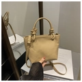 Detail of khaki lychee leather bucket bag featuring unique thick rope knot handle design - Khaki Without Pendant