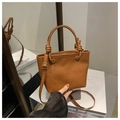 Detail of caramel brown textured leather bucket bag with knotted handle and gold hardware - Brown Without Pendant