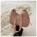 Close-up of pink butterfly shoulder bag showing metallic buckle and pleated leather texture - Pink