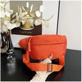 Detail of orange canvas crossbody bag with wide strap and woven rope zipper pull decoration - Orange