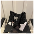 Detail of black pleated fabric handbag with silver metal butterfly ornament and zipper - Black