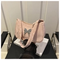 Close-up of pink ruched shoulder bag with a metallic silver butterfly buckle detail - Pink