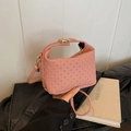 Pink woven handbag with gold hardware clasp and slender shoulder strap for women - Pink