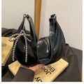 Detail of black crescent bag with wrinkled texture, Fashion logo and bow charm - Black