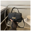 Black litchi pattern leather handbag with gold metal clasp and detachable strap - Black