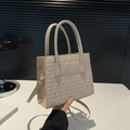 Beige quilted crossbody bag with top handles and adjustable strap in minimalist style - Khaki