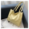 Detail of soft cream tote bag featuring stylish silver double metal rings on the strap - Yellow