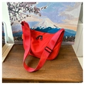 Detail of red crescent nylon bag with black double zippers and wide shoulder strap - Red