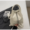 Detail of cream drawstring bucket backpack with silver butterfly buckle on grey blazer - Off White