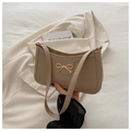 Elegant beige faux leather underarm bag featuring a stylish gold metal bow accent - Khaki