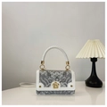 Elegant white leather and gray patterned fabric crossbody bag with a gold flower clasp - White & Gray