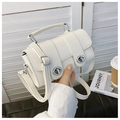 Close-up of white crocodile texture leather handbag with silver double twist lock detail - Off White