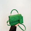 Detail of bright green quilted handbag with FASHION lettering and detachable coin purse - Green