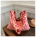Pink leopard print canvas tote bag with large capacity on a wooden table setup - Pink