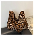 Large leopard print tote bag with shoulder strap displayed on a modern leather sofa - Brown