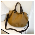 Detail of tan canvas tote bag with adjustable shoulder strap and metal eyelet accents - Khaki