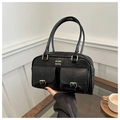 Detail of black faux leather Boston bag with metal buckles and gold brand lettering - Black