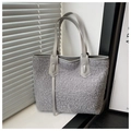 Detail of grey faux shearling tote bag with leather straps and soft curly plush texture - Gray