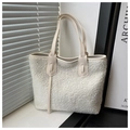 Detail of white sherpa tote bag showing soft fleece texture and cream leather handles - White