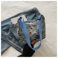 Floral print knit hobo bag in light beige with adjustable blue nylon shoulder strap - Light Blue