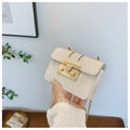 Detail of a mini beige crossbody bag featuring a golden square lock and slim chain strap - Off White