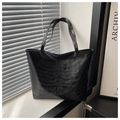 Detail of black tote bag featuring unique embossed skeleton rib cage design on matte PU leather - Black
