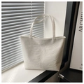 Detail of white tote bag featuring 3D embossed rib texture and minimalist handles - White