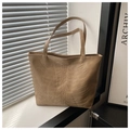 Macro detail of khaki tote bag featuring unique 3D rib bone embossed texture on PU leather - Khaki