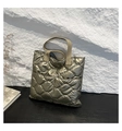 Detail of quilted metallic tote bag with puffer texture and bronze finish on wood - Gold