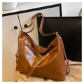 Detail of caramel brown retro tote bag with adjustable straps and golden hardware - Brown