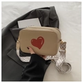 Beige camera bag with red heart print and wide geometric strap in a fashion context - Khaki