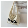 Minimalist off-white canvas tote bag featuring large MOOD text with a wide shoulder strap - White