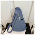 Detailed view of the blue nylon crossbody bag featuring textured fabric and side metal logo - Blue