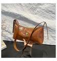 Detail of caramel glossy leather bag with silver star ornament and adjustable strap - Brown