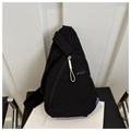 Detail of black nylon chest bag with white zipper puller and adjustable strap - Black