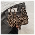 Detail showing the retro leopard print texture and gold metal buckle on the crescent bag - Brown