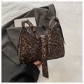 Close-up of leopard print handbag with premium gold metal buckles and leather texture - Coffee