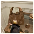 Detail of dark brown pleated textured tote bag with brand logo and silver metal hardware - No Pendant / Coffee