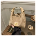 Detailed close-up of a beige crescent hobo bag with top metal handle and branded logo patch - No Pendant / Khaki