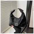Detail of a black crescent hobo bag with vintage texture and circular metal handle - No Pendant / Black