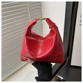 Detailed view of red crescent tote bag featuring golden metal buckles and embossed logo - No Pendant / Red
