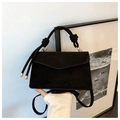 Matte black crossbody bag with knot handle and elegant gold-toned metal details - Black