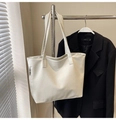 Close-up of white tote bag showing natural leather texture and metal zipper detail - White