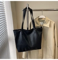Detail of black PU leather tote bag showing rich lychee texture and side silver zipper accent - Black