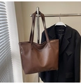Detail of a brown PU leather tote bag featuring a functional side zipper and soft texture - Brown